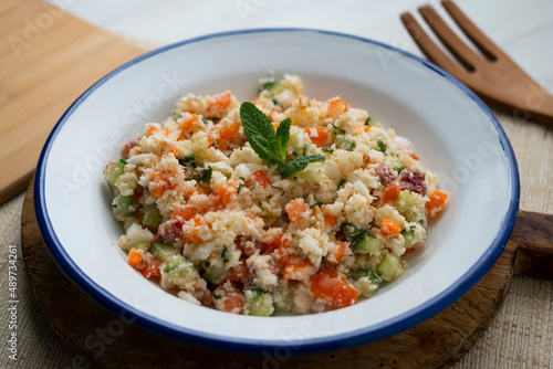 Fake couscous made with crushed cauliflower, green pepper and other vegetables. vegan recipe.