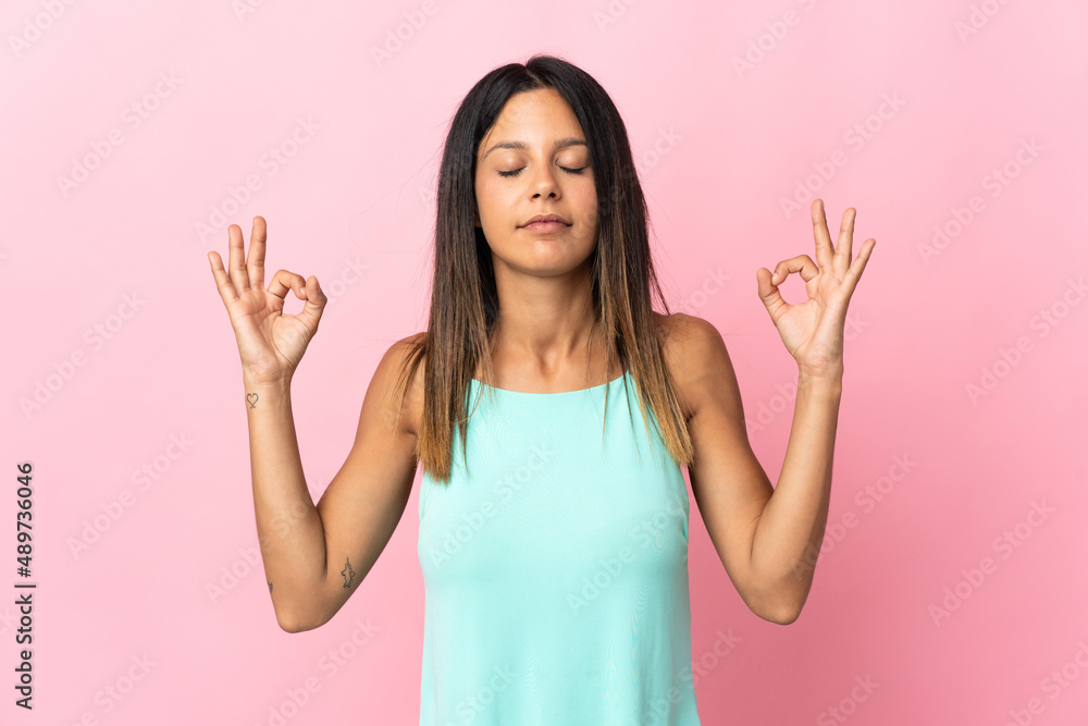 Caucasian girl isolated on pink background in zen pose Caucasian girl isolated on pink background in zen pose