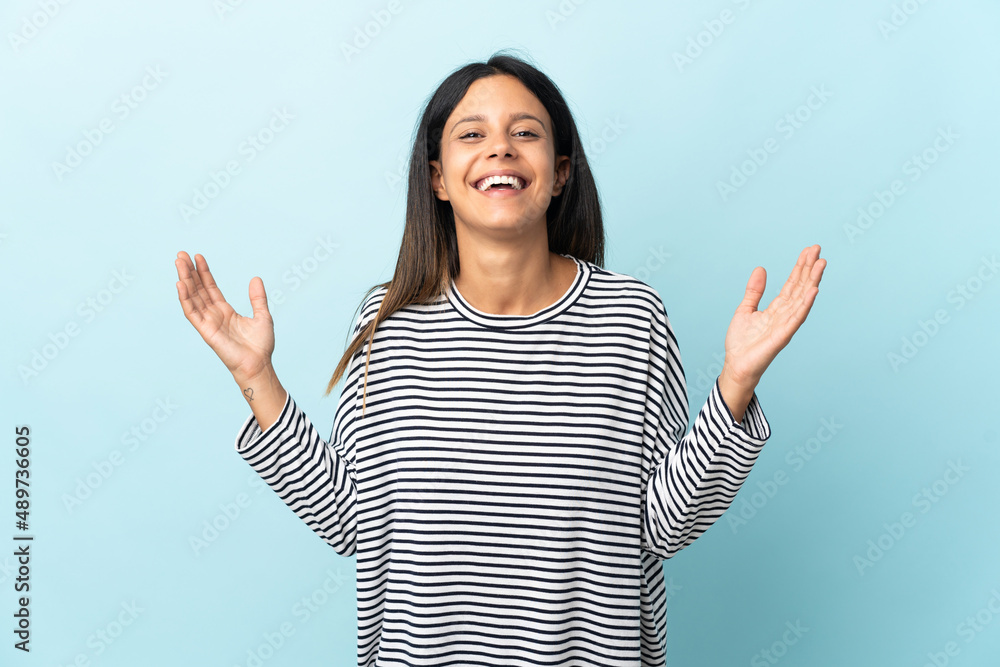 Caucasian girl isolated on blue background smiling a lot Caucasian girl isolated on blue background smiling a lot