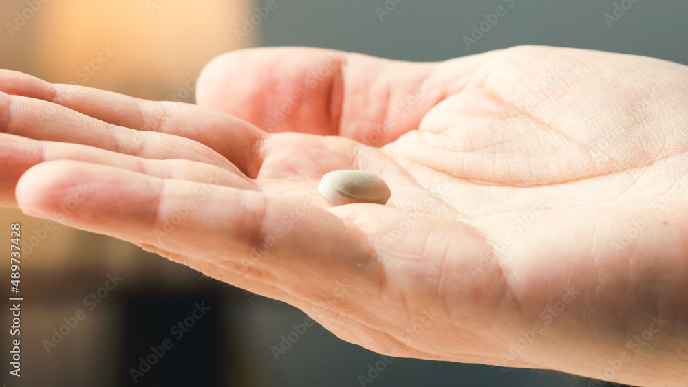 Close up of withe pills on hand Close up of withe pills on hand
