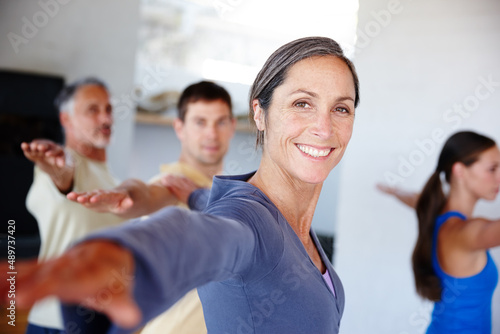 Positive outlook on health. A group of people taking a class together at gym.