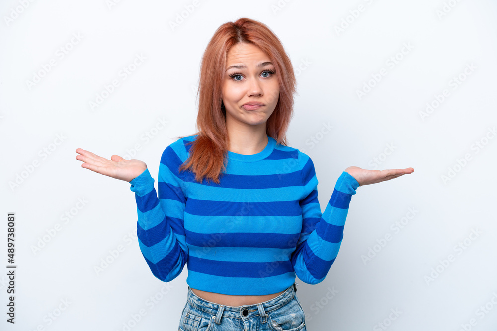 Young Russian girl isolated on white background having doubts while raising hands Young Russian girl isolated on white background having doubts while raising hands