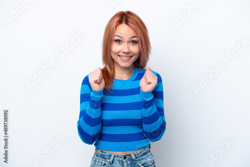 Young Russian girl isolated on white background celebrating a victory in winner position