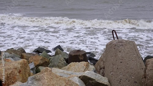 storm at sea. Waves hitting the breakwater
