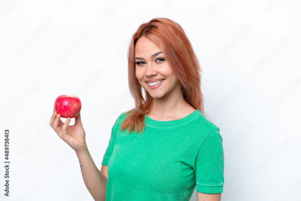 Young Russian girl with an apple isolated on white background smiling a lot Young Russian girl with an apple isolated on white background smiling a lot