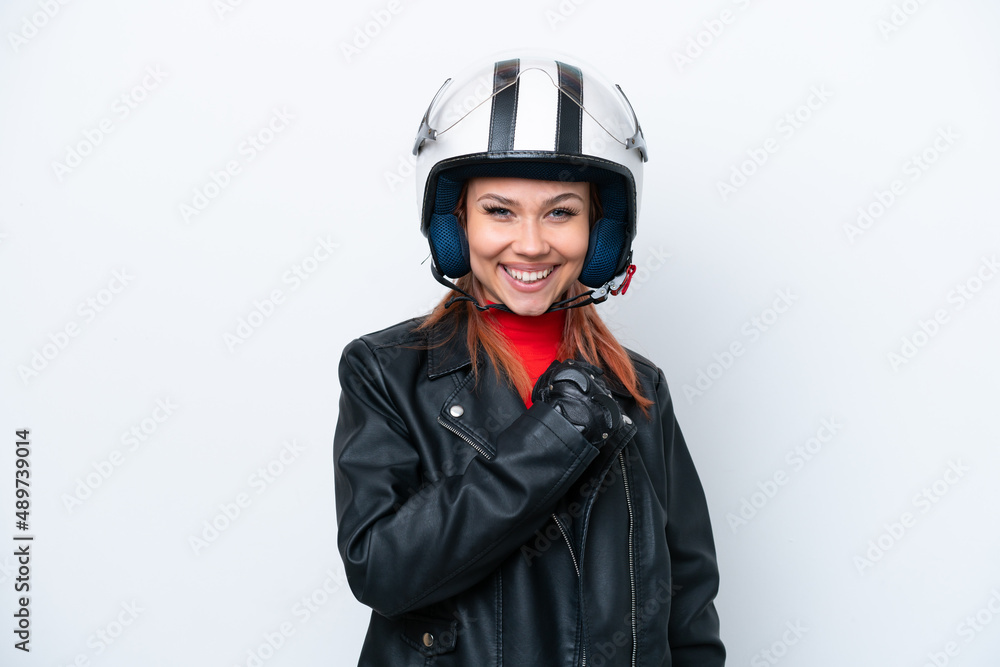 Young Russian girl with a motorcycle helmet isolated on white background celebrating a victory Young Russian girl with a motorcycle helmet isolated on white background celebrating a victory