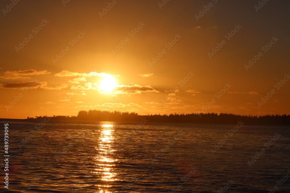 sunset over the sea in Tetiaroa in a pacific island fron French Polynesia 