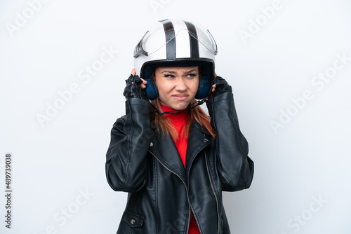 Young Russian girl with a motorcycle helmet isolated on white background frustrated and covering ears