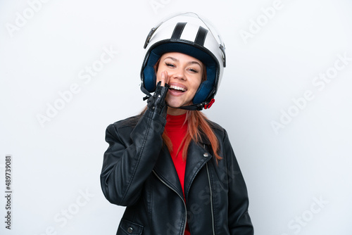 Young Russian girl with a motorcycle helmet isolated on white background shouting with mouth wide open