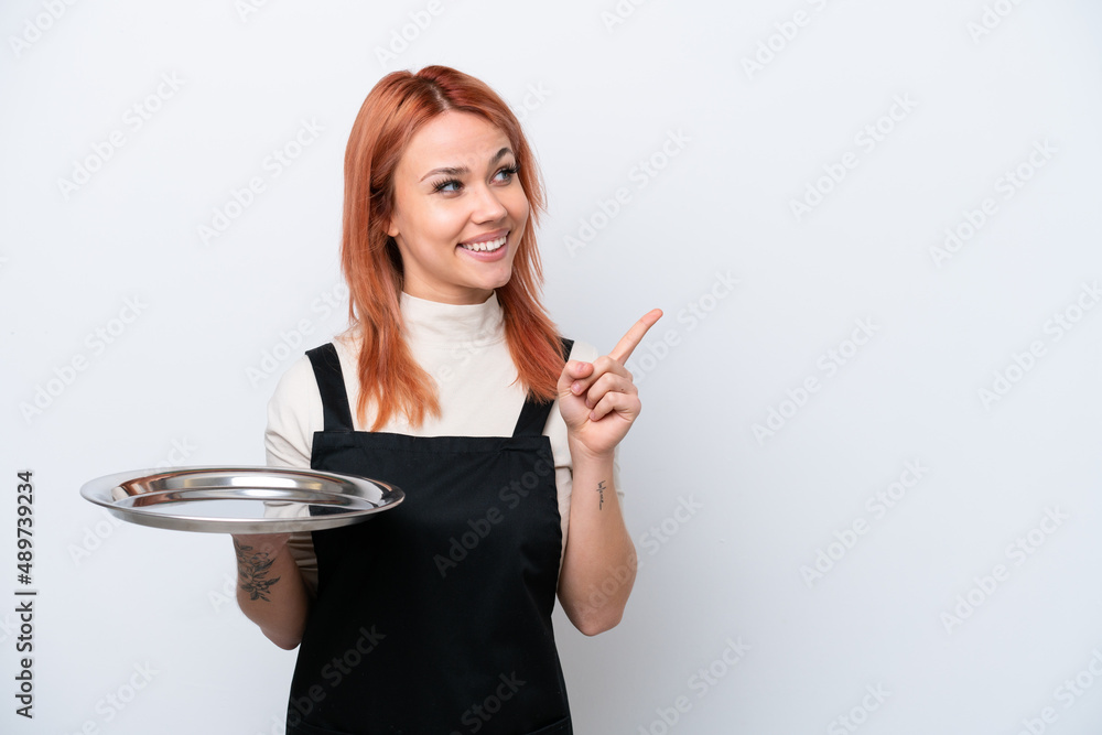 Young Russian waiter with tray isolated on white background intending to realizes the solution while lifting a finger up Young Russian waiter with tray isolated on white background intending to realizes the solution while lifting a finger up