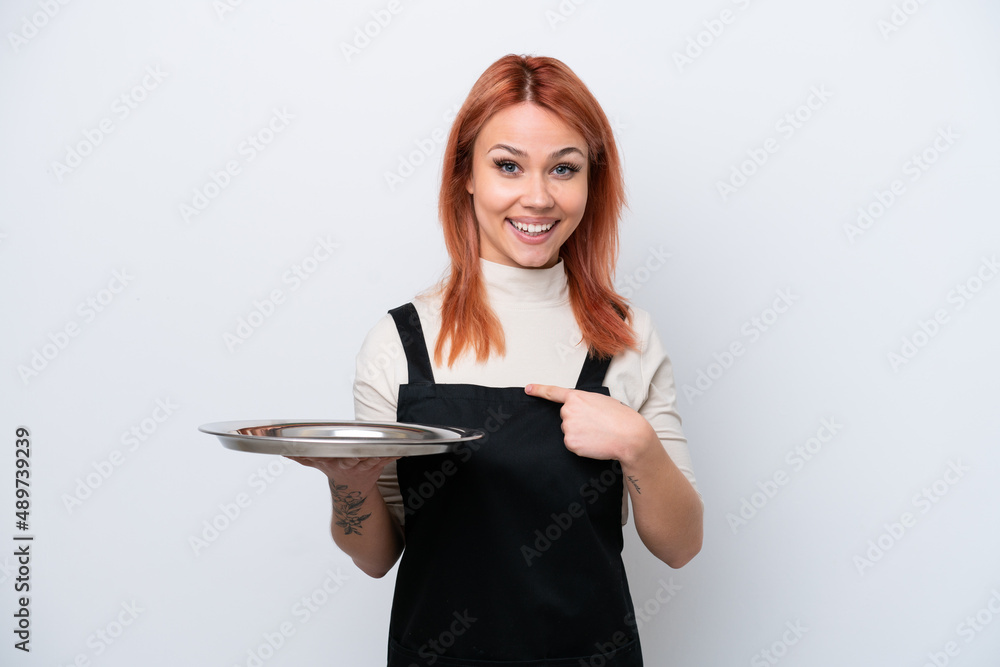 Young Russian waiter with tray isolated on white background with surprise facial expression Young Russian waiter with tray isolated on white background with surprise facial expression