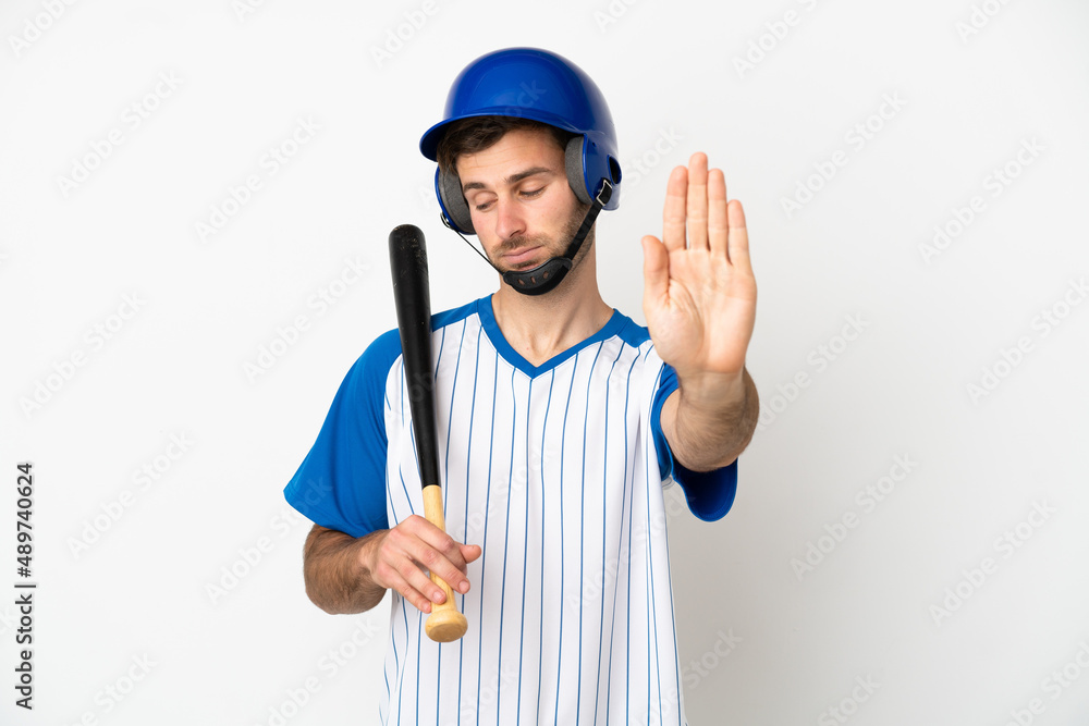 Young caucasian man playing baseball isolated on white background making stop gesture and disappointed Young caucasian man playing baseball isolated on white background making stop gesture and disappointed