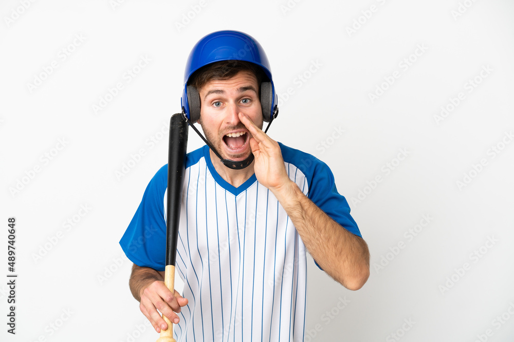 Young caucasian man playing baseball isolated on white background shouting with mouth wide open