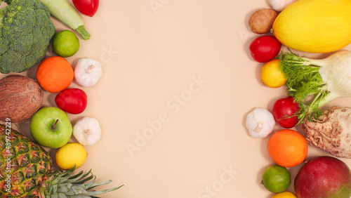 Creative fook copy space background with fresh and organic fruits and vegetables against pastel beige background. FLat lay