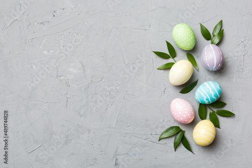 Colorful Easter eggs with spring flower leaf isolated over white background. Colored Egg Holiday border