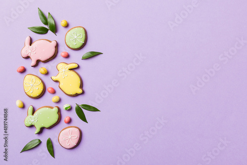 holiday preparation Multi colors Easter eggs with cookies on colored background . Pastel color Easter eggs. holiday concept with copy space