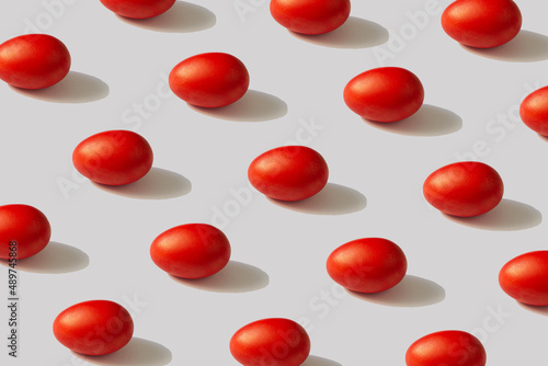 Pattern of red eggs on a gray background. The concept of minimal food.Easter photo