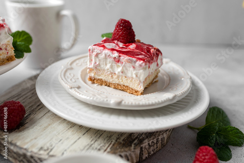 Raspberry bar cheesecake with whipped topping and fresh raspberries. tasty dessert. 