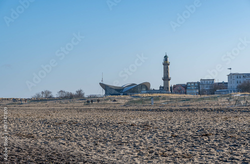 beach with lighthouse in warnemuende  germany in the background  sky with no clouds 