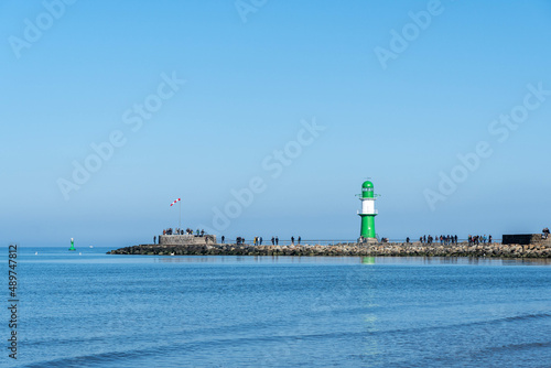 lighthouse in the port of warnemuende germany during sunny summerday