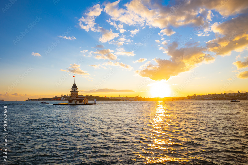 Maiden's Tower or Kiz Kulesi with cityscape of Istanbul at sunset