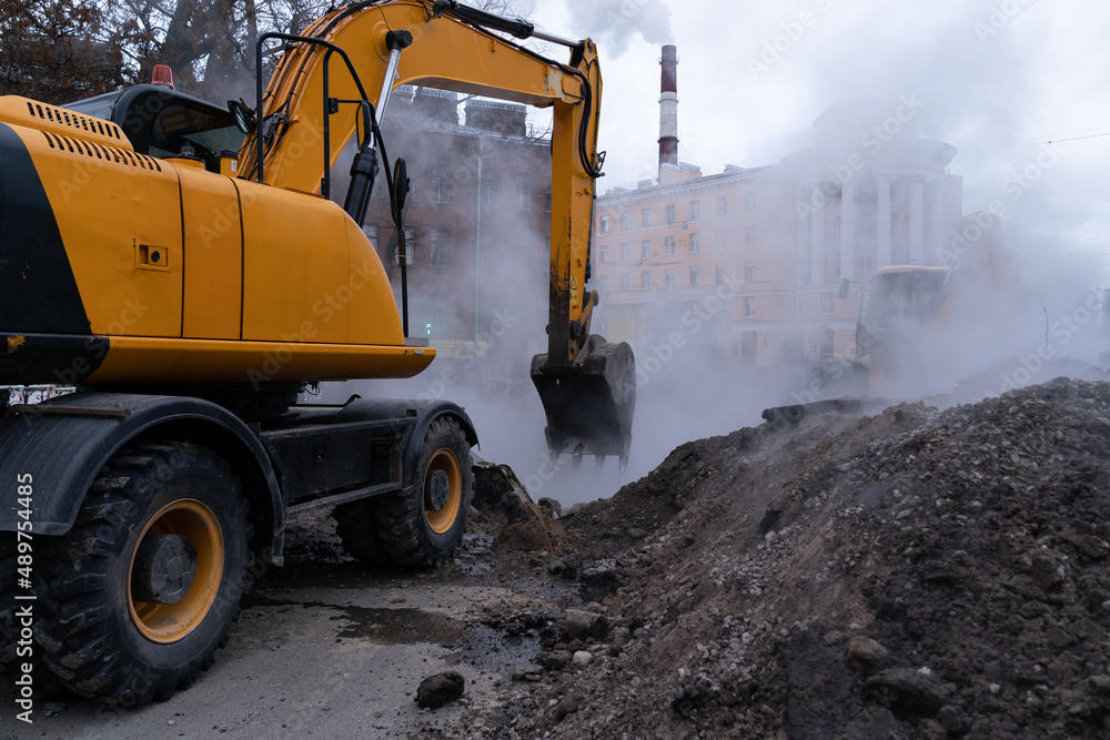 Emergency service team of municipal services working on liquidation of hot water pipeline accident or canalization, hot steam from the pit. Elimination of accident of underground utilities in Russia Emergency service team of municipal services working on liquidation of hot water pipeline accident or canalization, hot steam from the pit. Elimination of accident of underground utilities in Russia