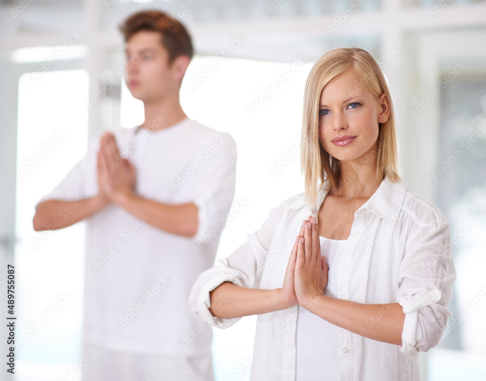 Serentiy. Shot of two young people doing yoga together. Serentiy. Shot of two young people doing yoga together.