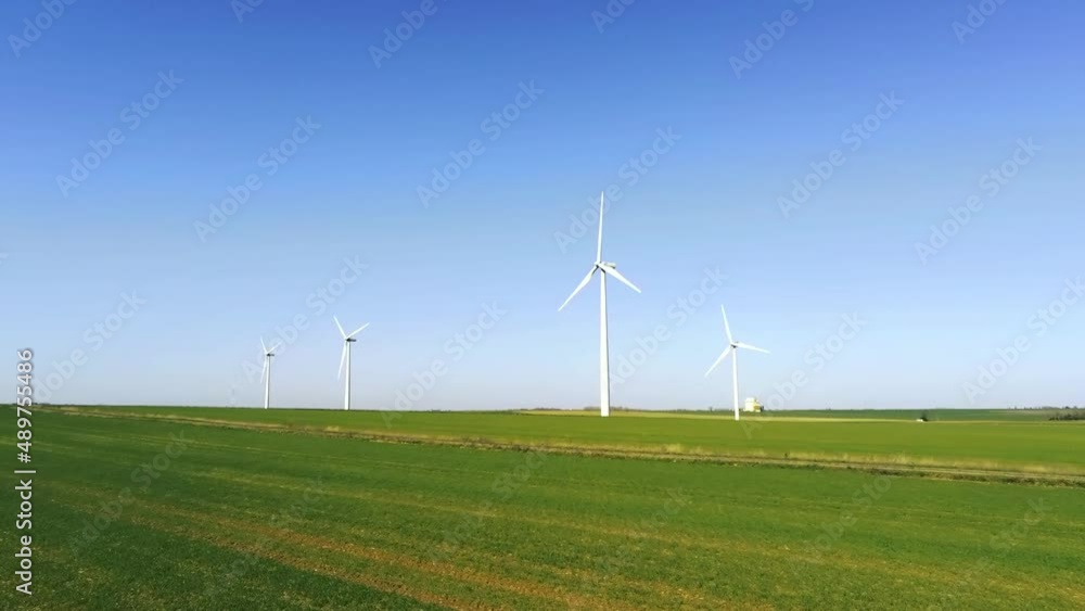 Wind farm composed of many wind turbines in an area of fields in France - aerial drone view with dolly zoom in - green and renewable energy Wind farm composed of many wind turbines in an area of fields in France - aerial drone view with dolly zoom in - green and renewable energy