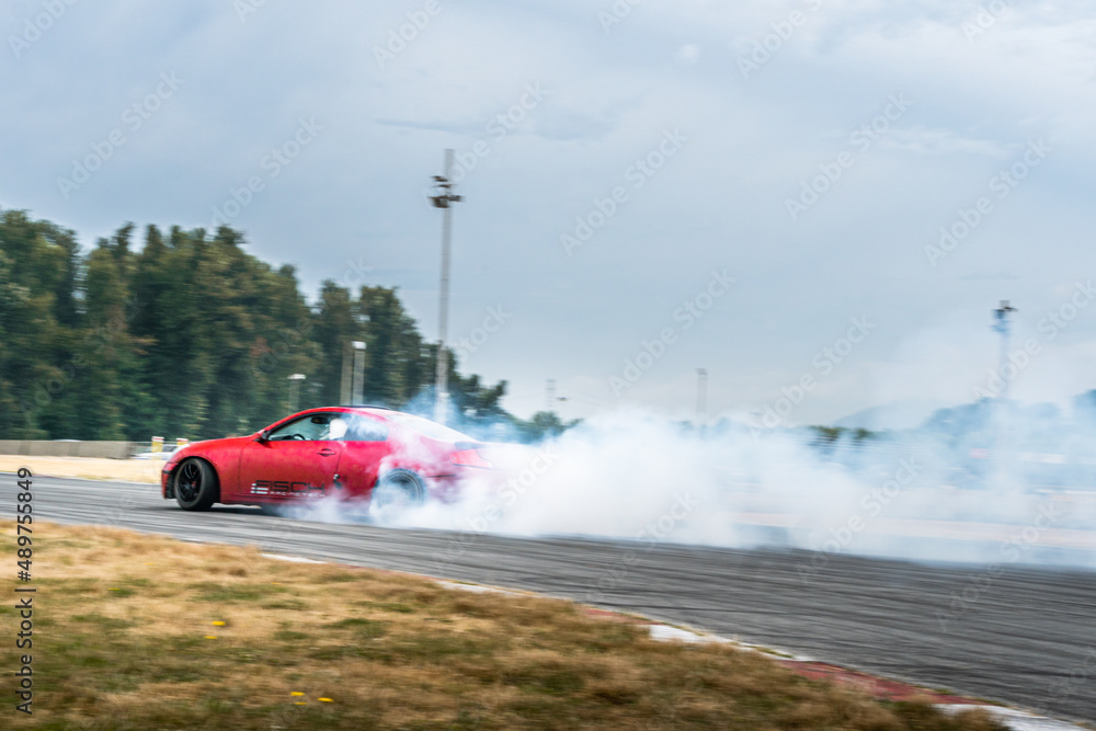 Red Drift Car / Race car drifting around corner very fast with lots of