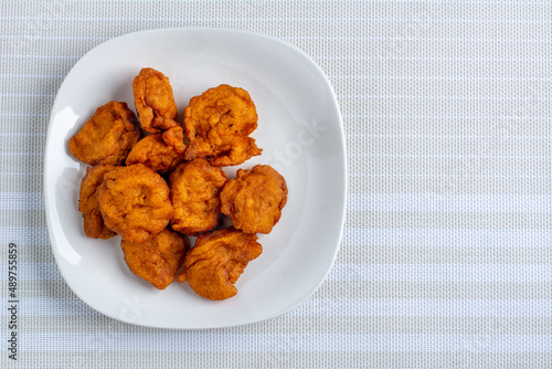 Akara balls in a white ceramic plate on a textured background