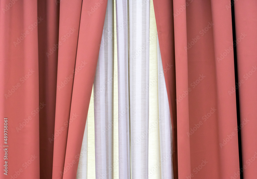 Terracotta and white curtains on the living room window.