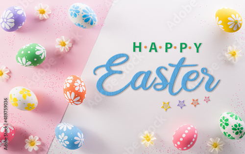 Happy easter decoration concept. Colourful Easter eggs and flowers with the text on pink and white background. © Siam