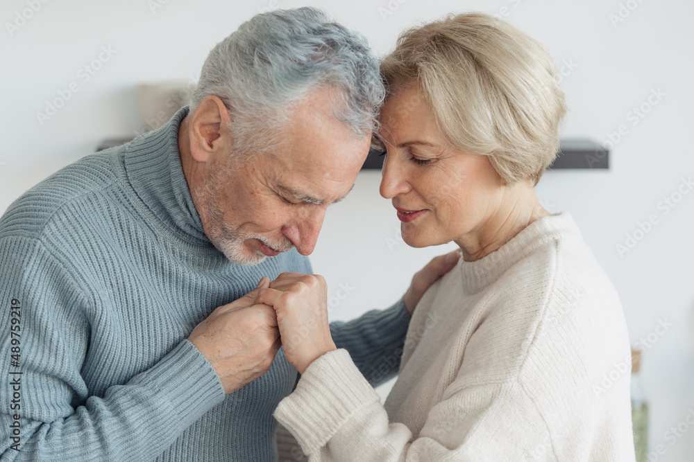 Retired enamored husband kissing his wife's hands Retired enamored husband kissing his wife's hands