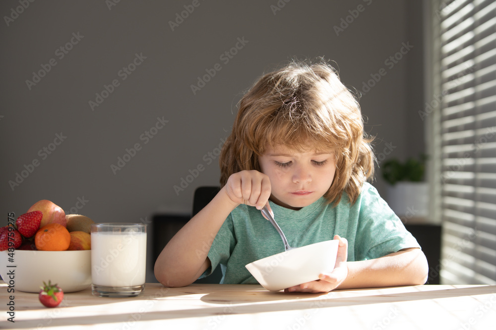 Caucasian toddler child boy eating healthy soup in the kitchen. Caucasian toddler child boy eating healthy soup in the kitchen.