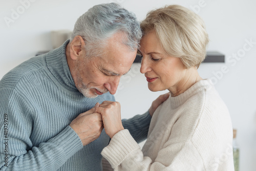 Retired enamored husband kissing his wife's hands