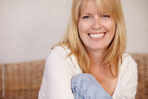 Im comfortable in my own skin. A beautiful mature woman smiling in her home. © Marine G/peopleimages.com