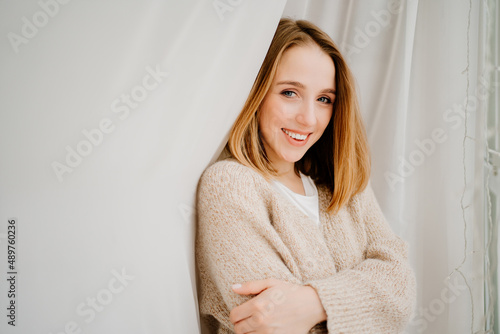 an attractive young woman in a cozy sweater. natural beauty and cosmetics.