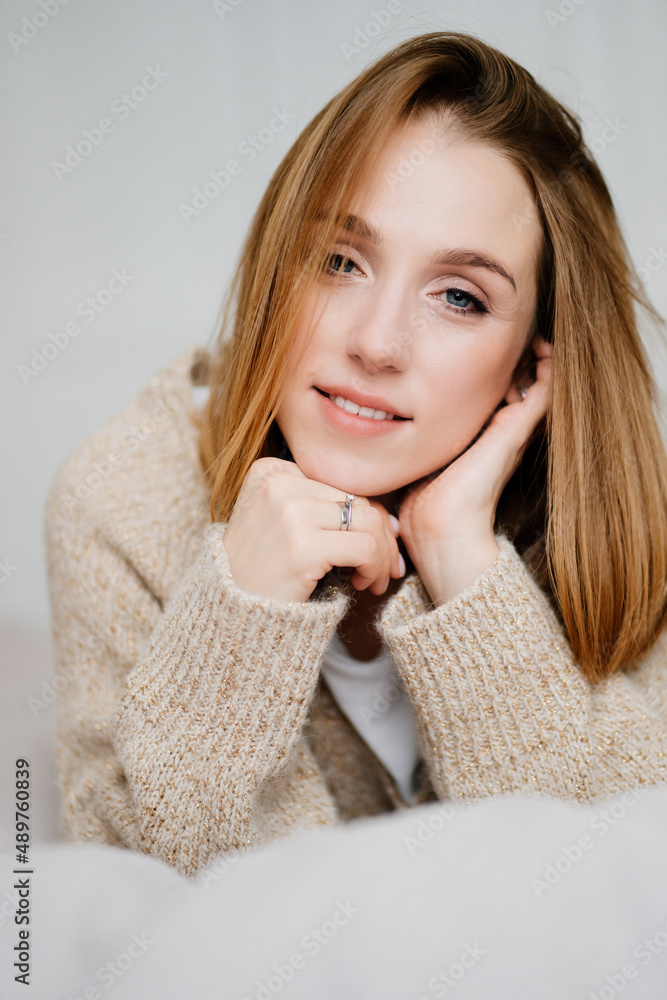 an attractive young woman in a cozy sweater. natural beauty and cosmetics. an attractive young woman in a cozy sweater. natural beauty and cosmetics.