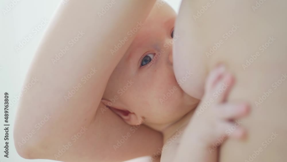 kid close-up. a mother feeds the baby with breast milk. the breastfeeding. kid close-up. a mother feeds the baby with breast milk. the breastfeeding.