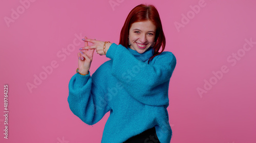 Hashtag. Cheerful teen girl showing hashtag symbol with hands, likes tagged message, popular viral content, sign to follow internet online trends. Young adult woman on pink indoor studio background