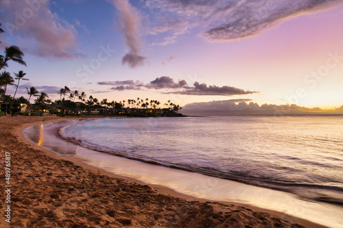 Tranquil scene of a pink sky msunset at Napili Bay on Maui.