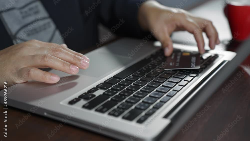 B roll SLOW MOTION of Hand typing the keyboard and shopping online while holding credit card. Cardholder holding credit card making e bank online payment. Paying for purchase in web store using laptop B roll SLOW MOTION of Hand typing the keyboard and shopping online while holding credit card. Cardholder holding credit card making e bank online payment. Paying for purchase in web store using laptop