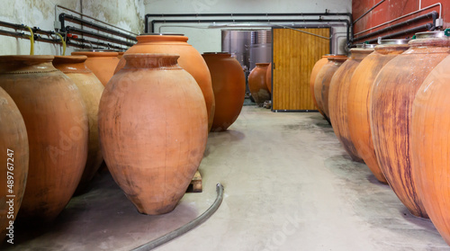 Interior of winery with big clay vessels for wine fermentation © JackF