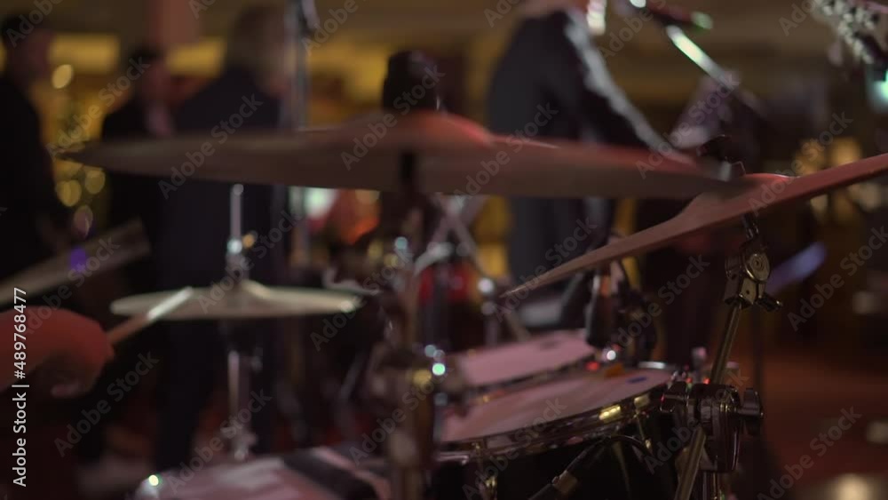 Drummer musician playing drums at concert. Percussion musical instruments on stage. Man with drumsticks, rhythm and beat. Music band, stage light. Drummer musician playing drums at concert. Percussion musical instruments on stage. Man with drumsticks, rhythm and beat. Music band, stage light.