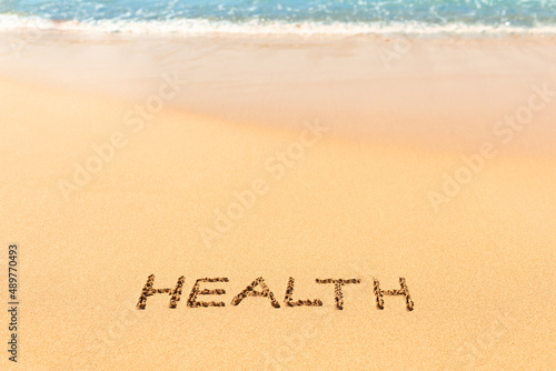 word health written on the sandy beach background. Healthy active lifestyle concept 