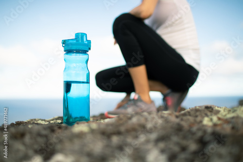 active fit female runner with bottle of water