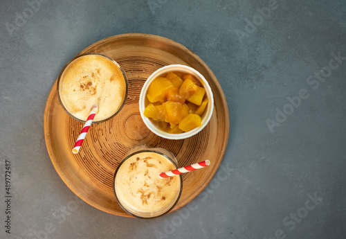 Yellow Indian mango yoghurt drink Mango Lassi or smoothie with turmeric and saffron.