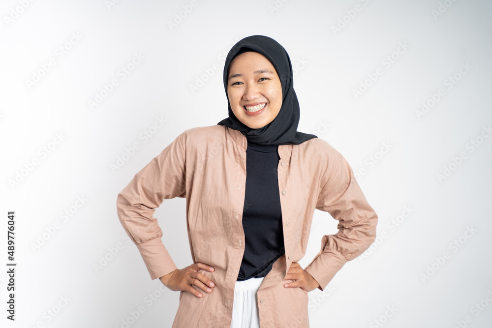 happy asian muslim woman stand with hands on hip