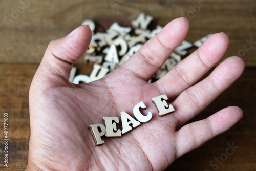 'hand holding a word. "PEACE"