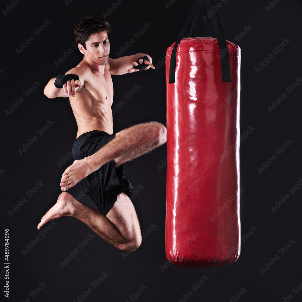 And any challenger will go down. Studio shot of a young mixed martial artist. And any challenger will go down. Studio shot of a young mixed martial artist.